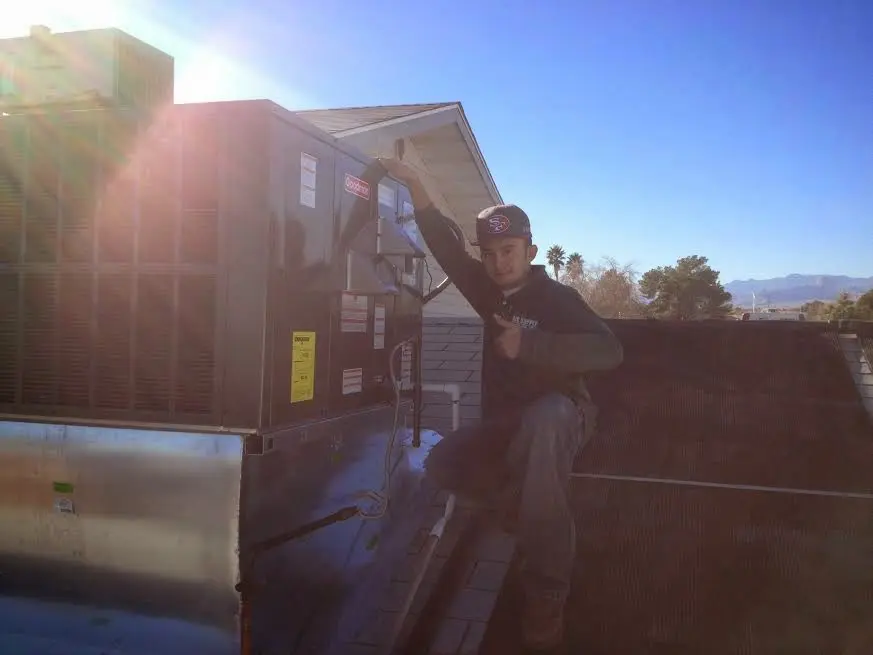 HVAC technician performing HVAC Inspection on a rooftop unit in East Orange